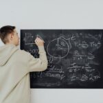 boy in beige hoodie solving a math problem
